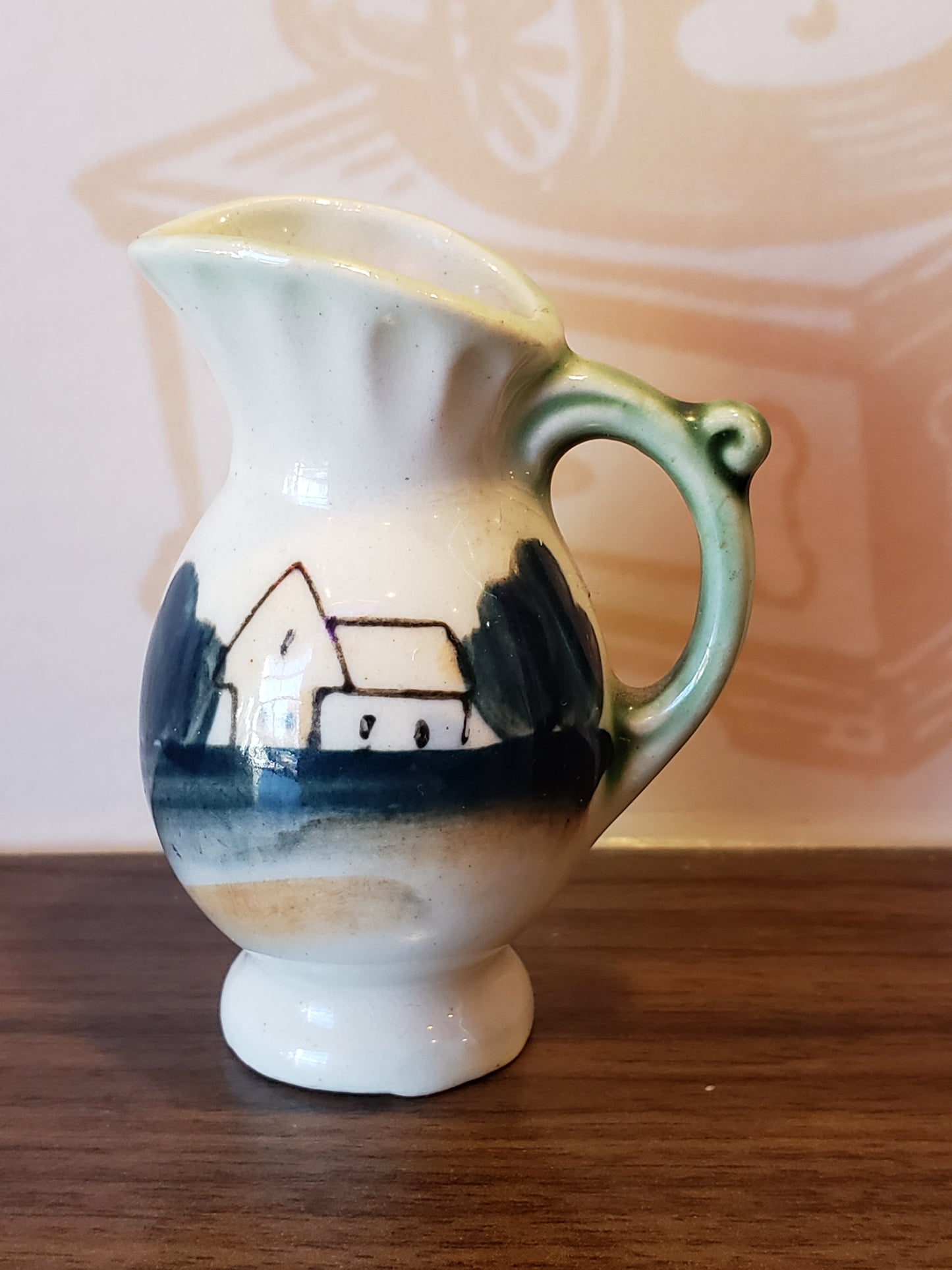 Miniature pottery pitcher with home scene