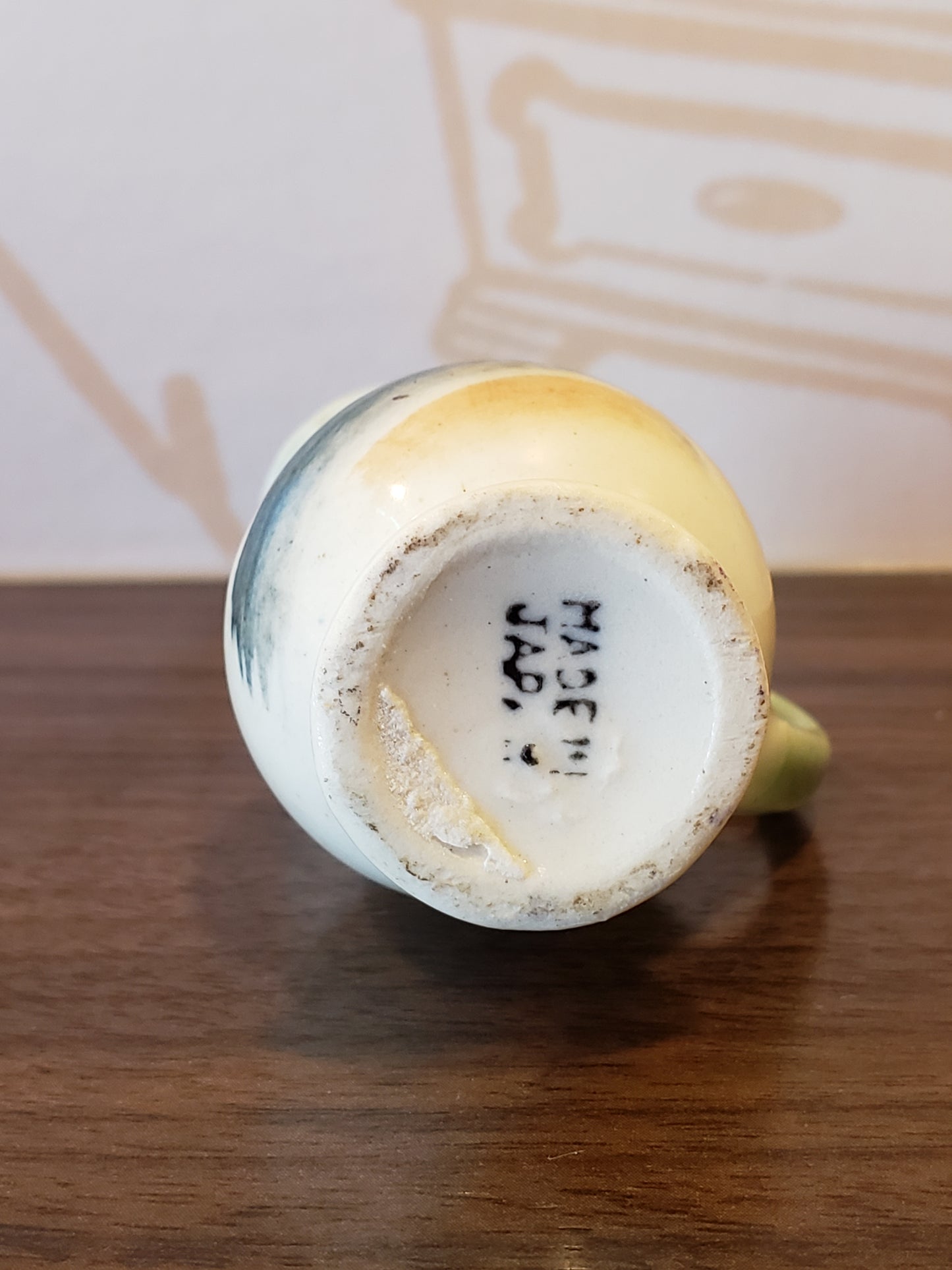 Miniature pottery pitcher with home scene