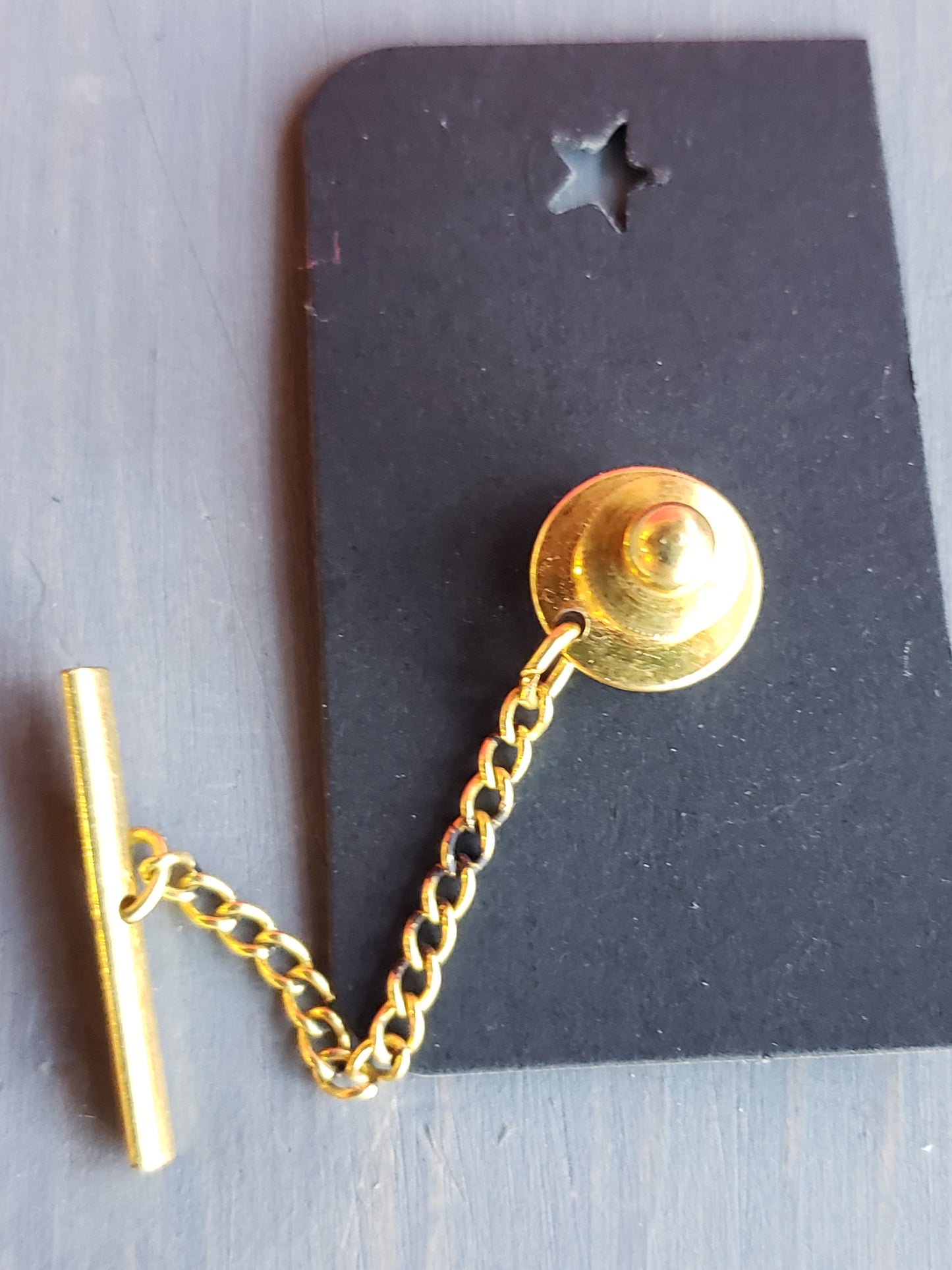 Shield and flame tie tack