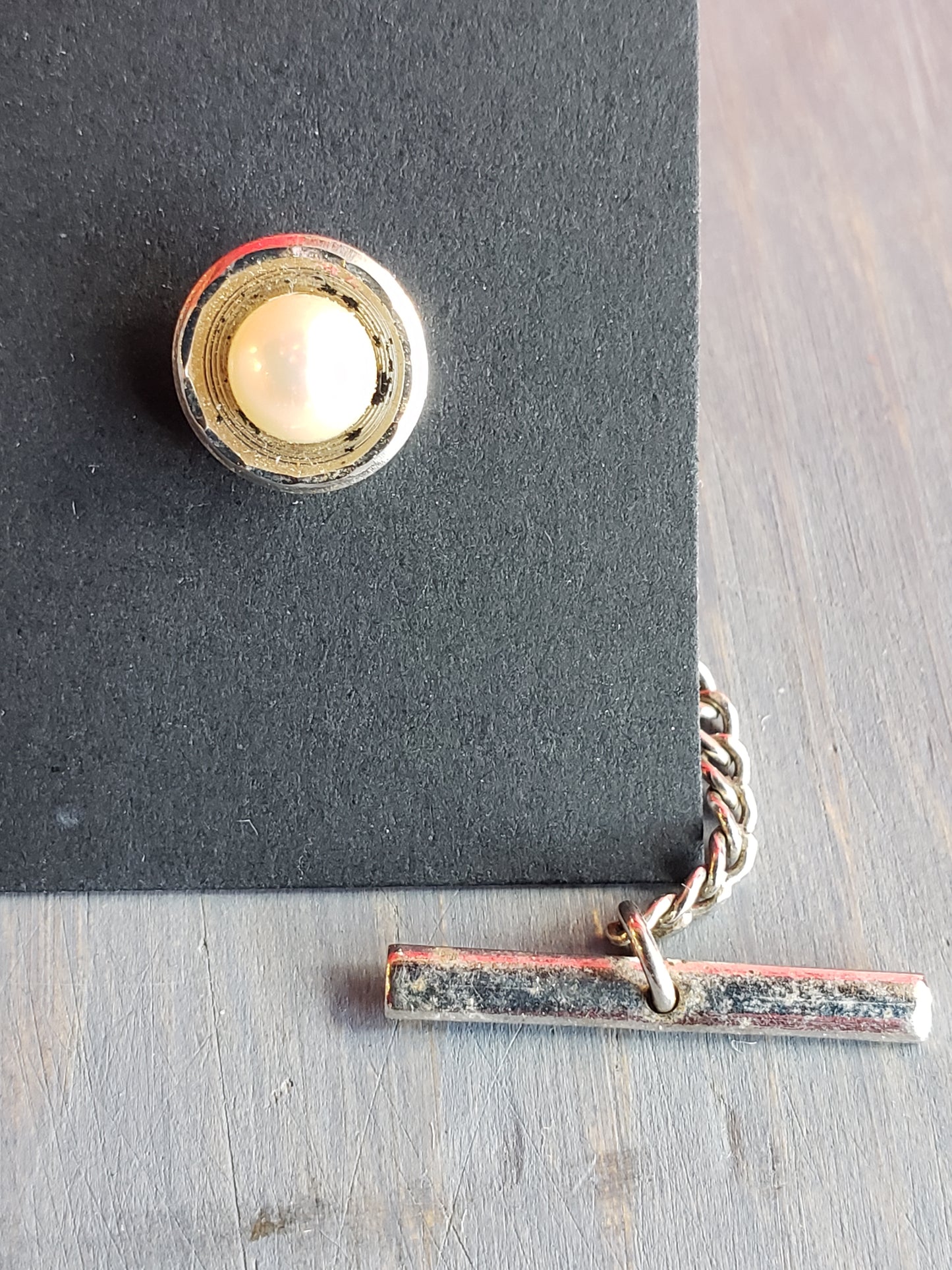 White bead in silver setting tie tack
