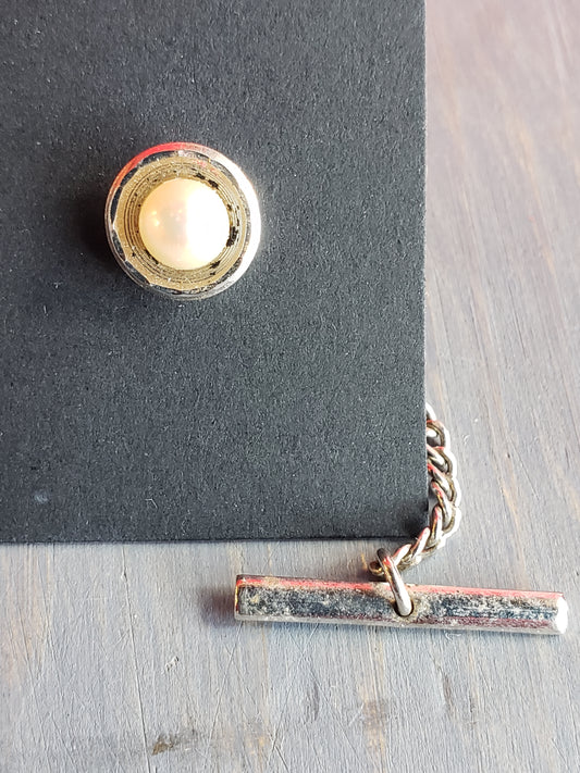 White bead in silver setting tie tack