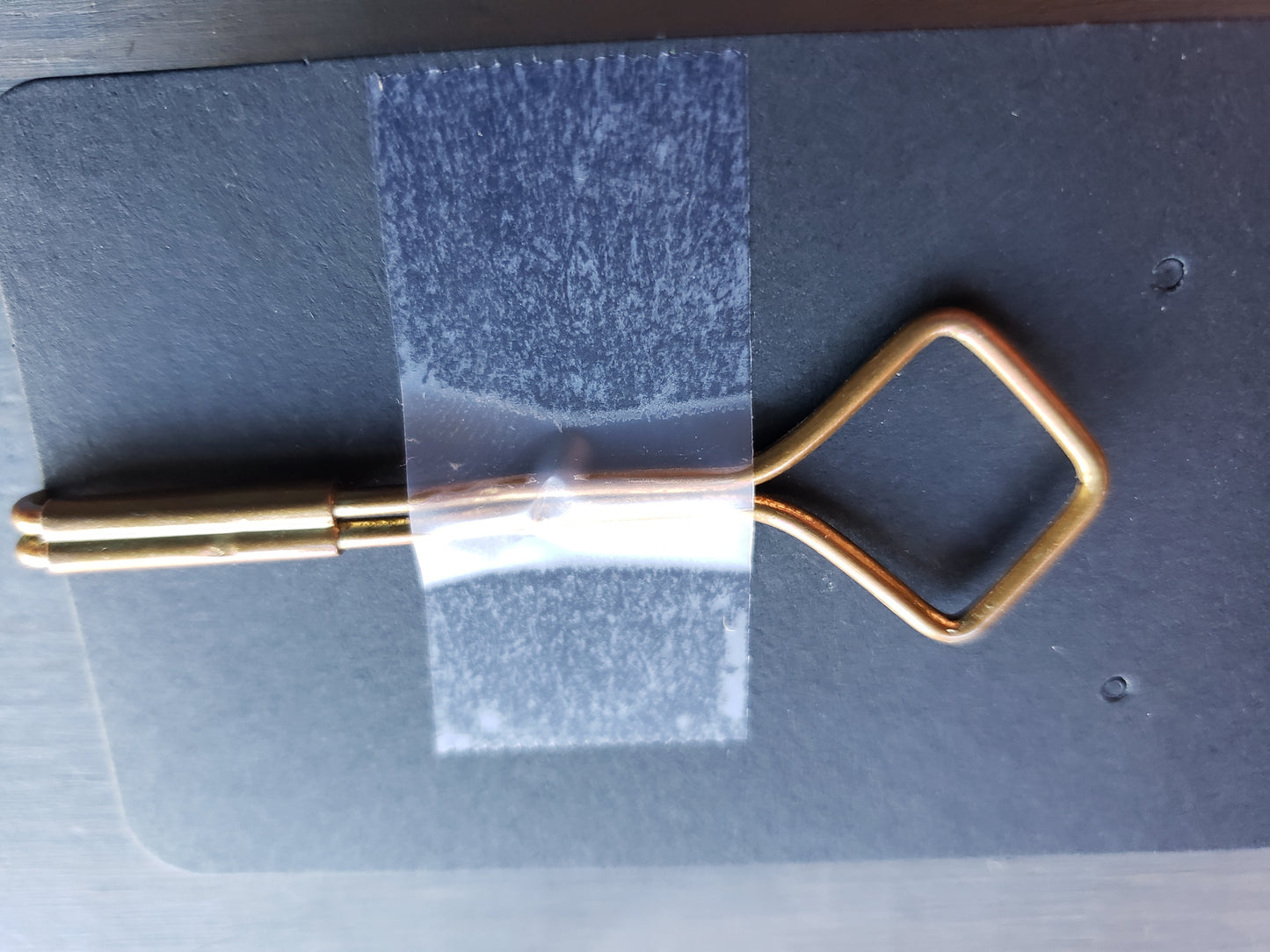 Brass and blue stone tie clip