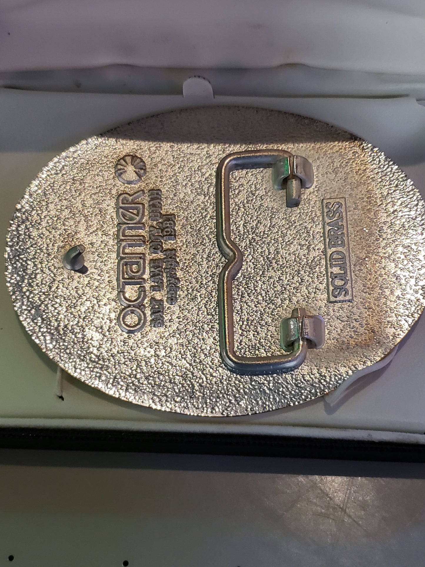 OC Tanner solid brass belt buckle