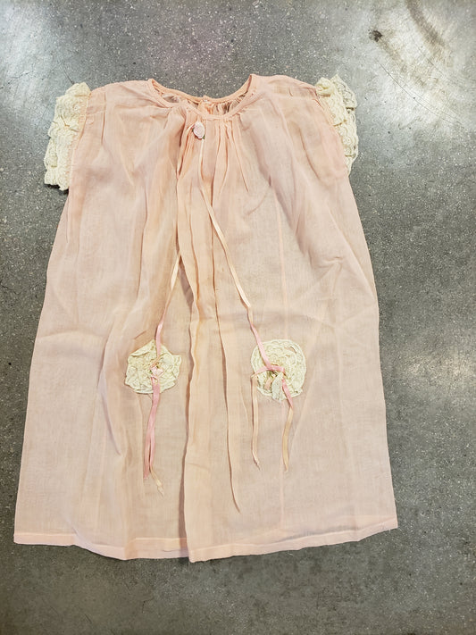Peach baby dress with lace rosettes