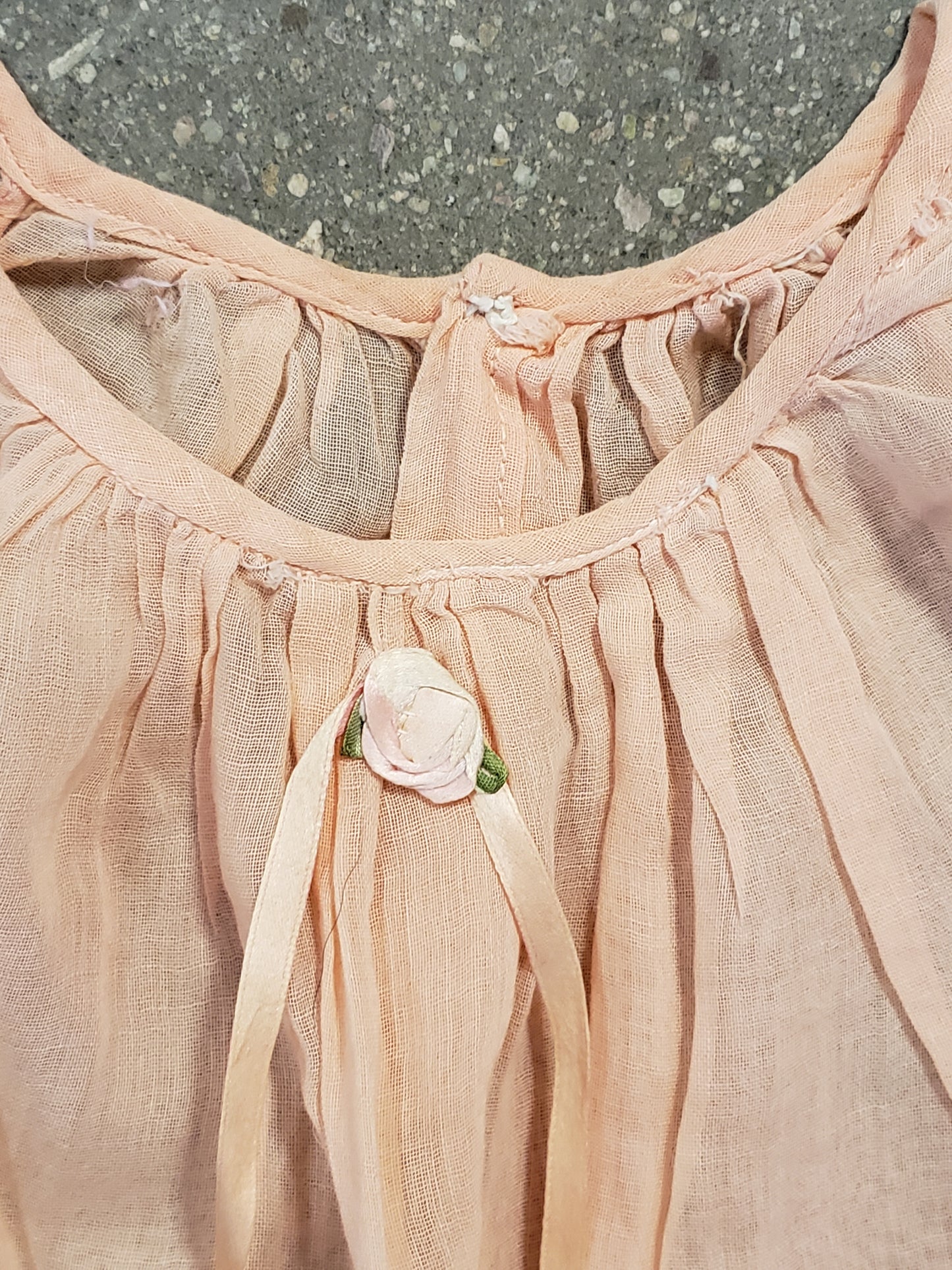 Peach baby dress with lace rosettes
