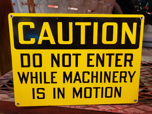 CAUTION DO NOT ENTER WHILE MACHINERY IS IN MOTION sign
