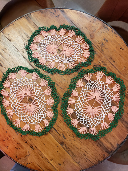 Set of three white, green and peach doilies