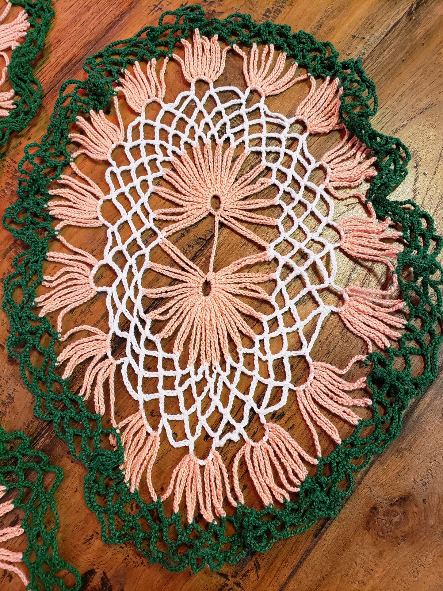 Set of three white, green and peach doilies