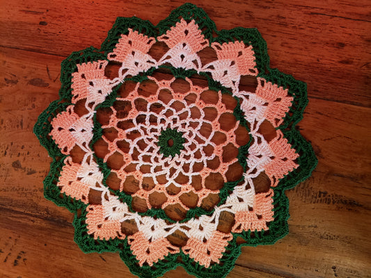 Round green, peach and white doily