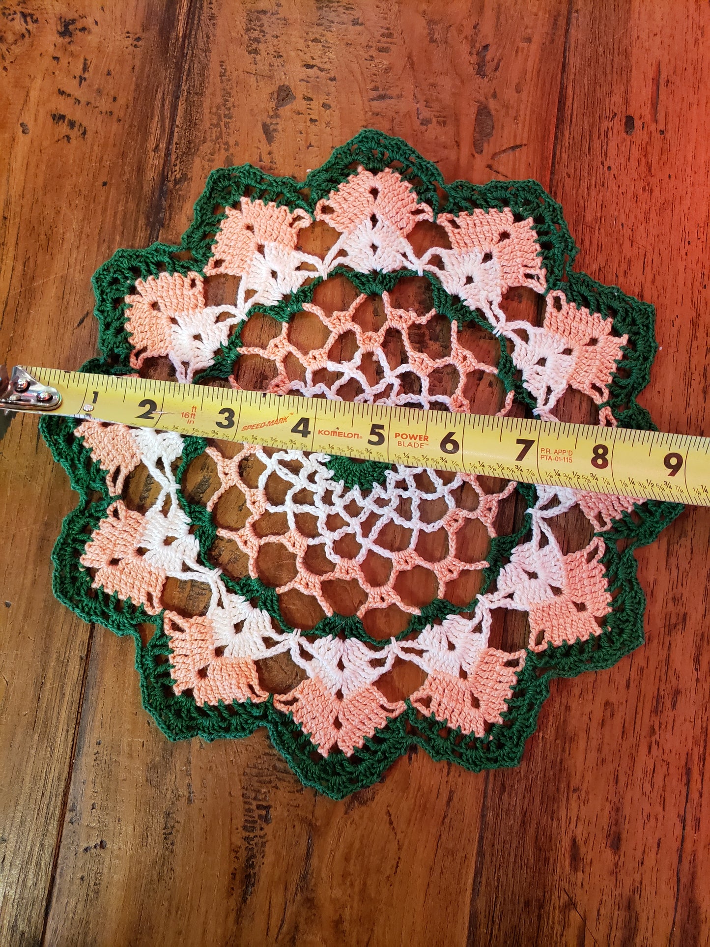 Round green, peach and white doily