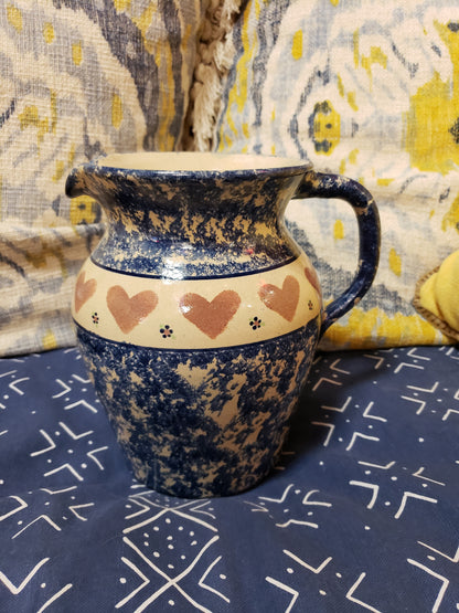 Blue speckled stoneware pitcher with hearts