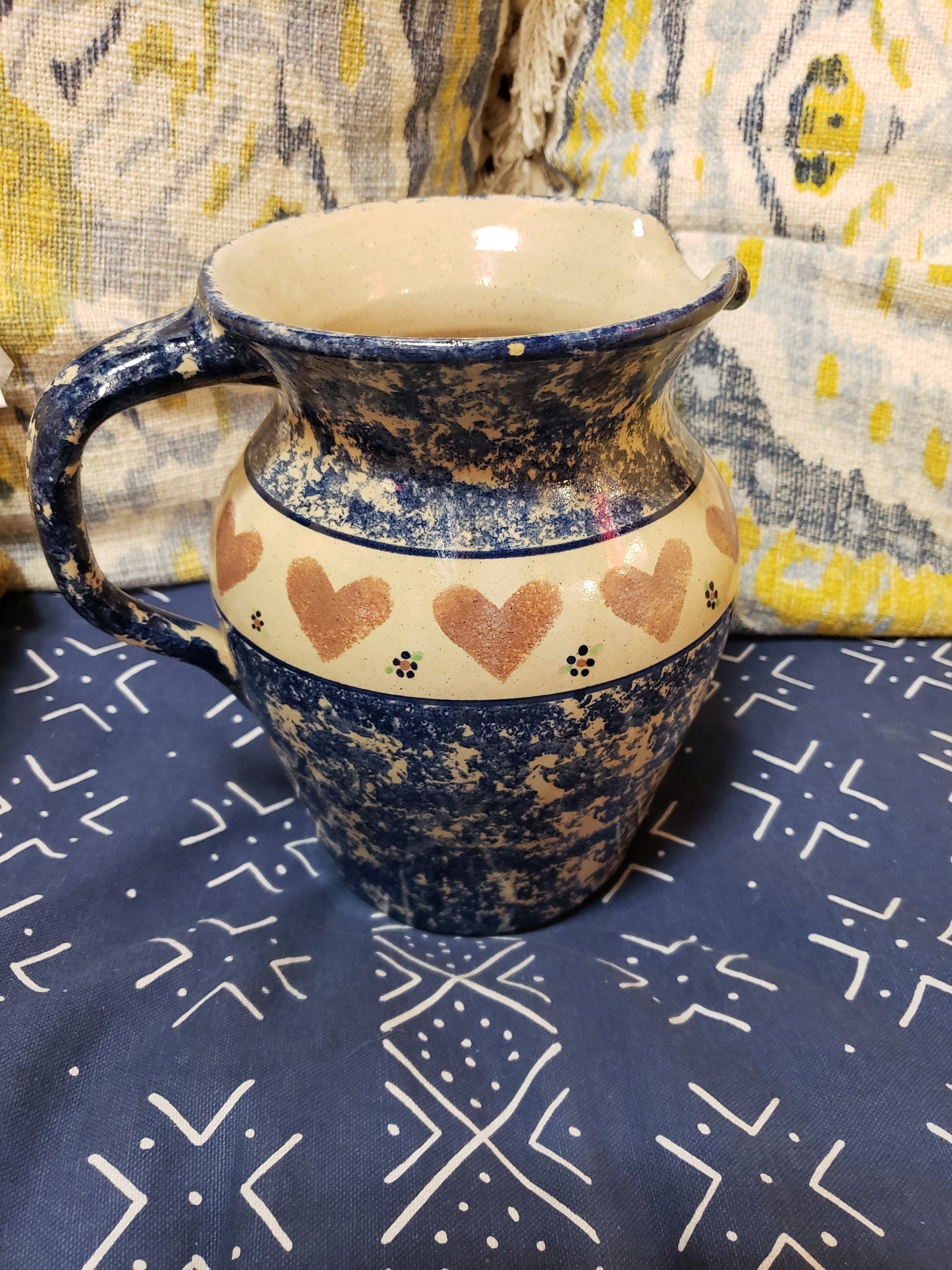 Blue speckled stoneware pitcher with hearts