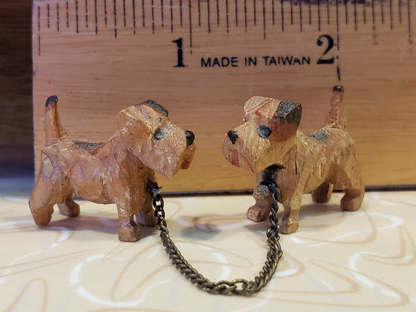 Tiny carved wooden dogs with chain