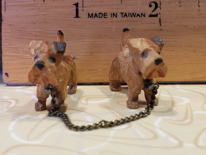 Tiny carved wooden dogs with chain