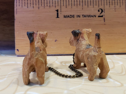 Tiny carved wooden dogs with chain