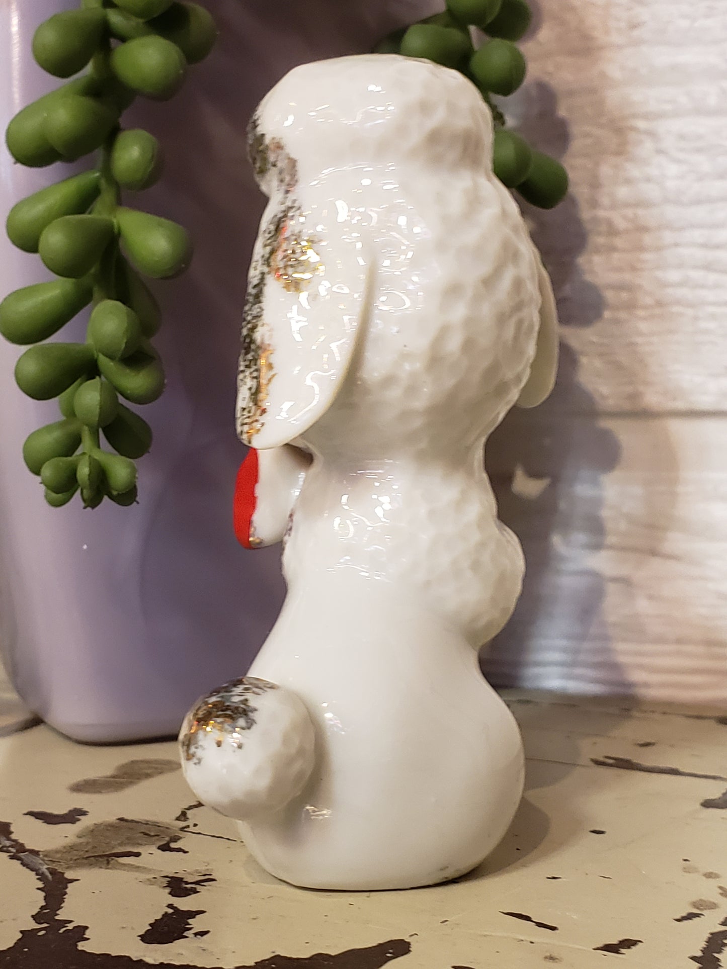 White poodle figurine with red bow