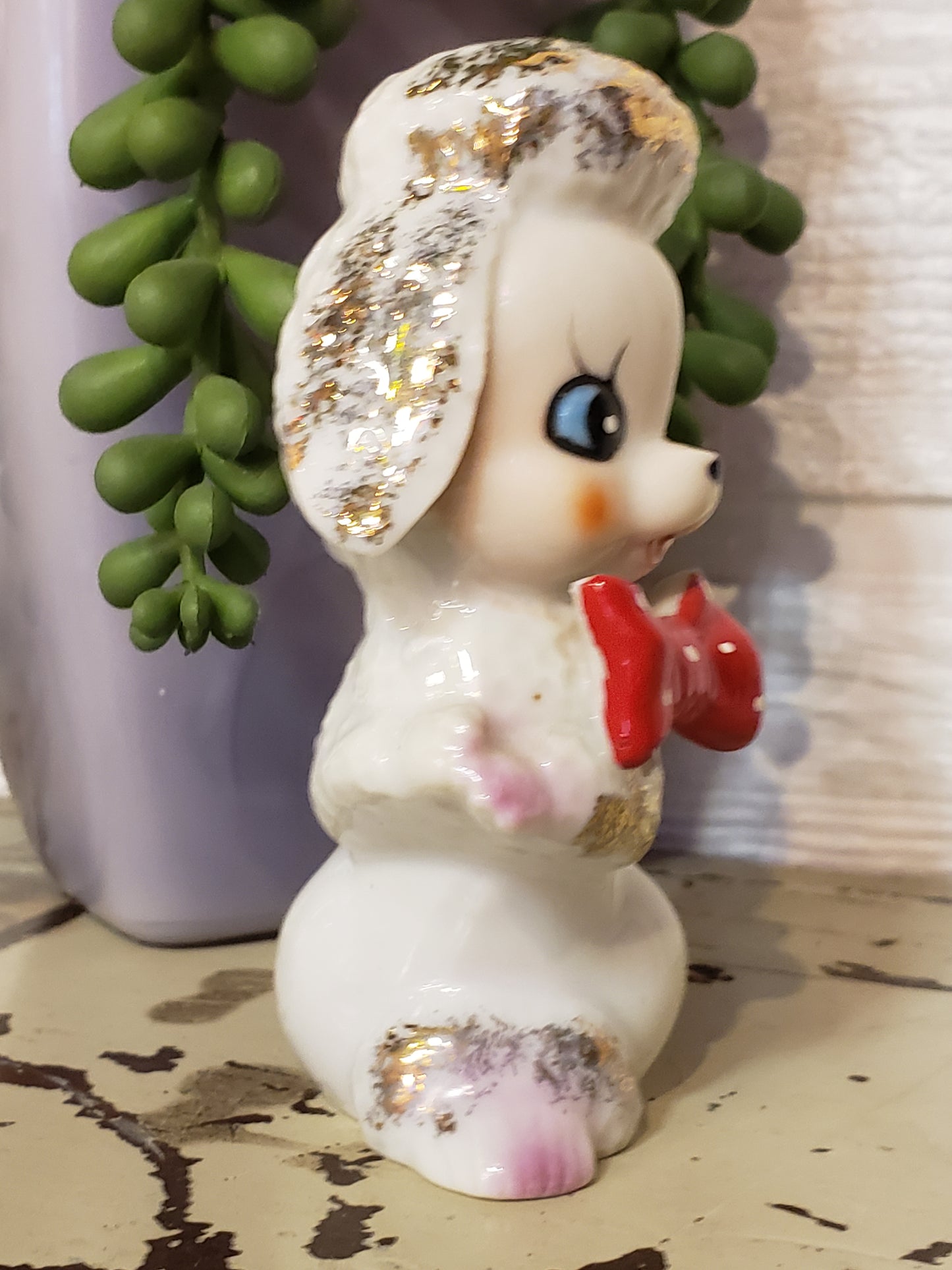 White poodle figurine with red bow