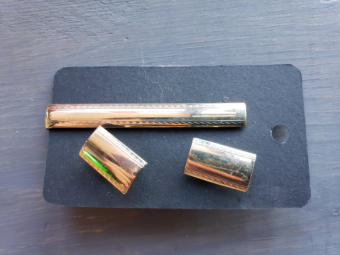 Golden tie bar and cufflink set