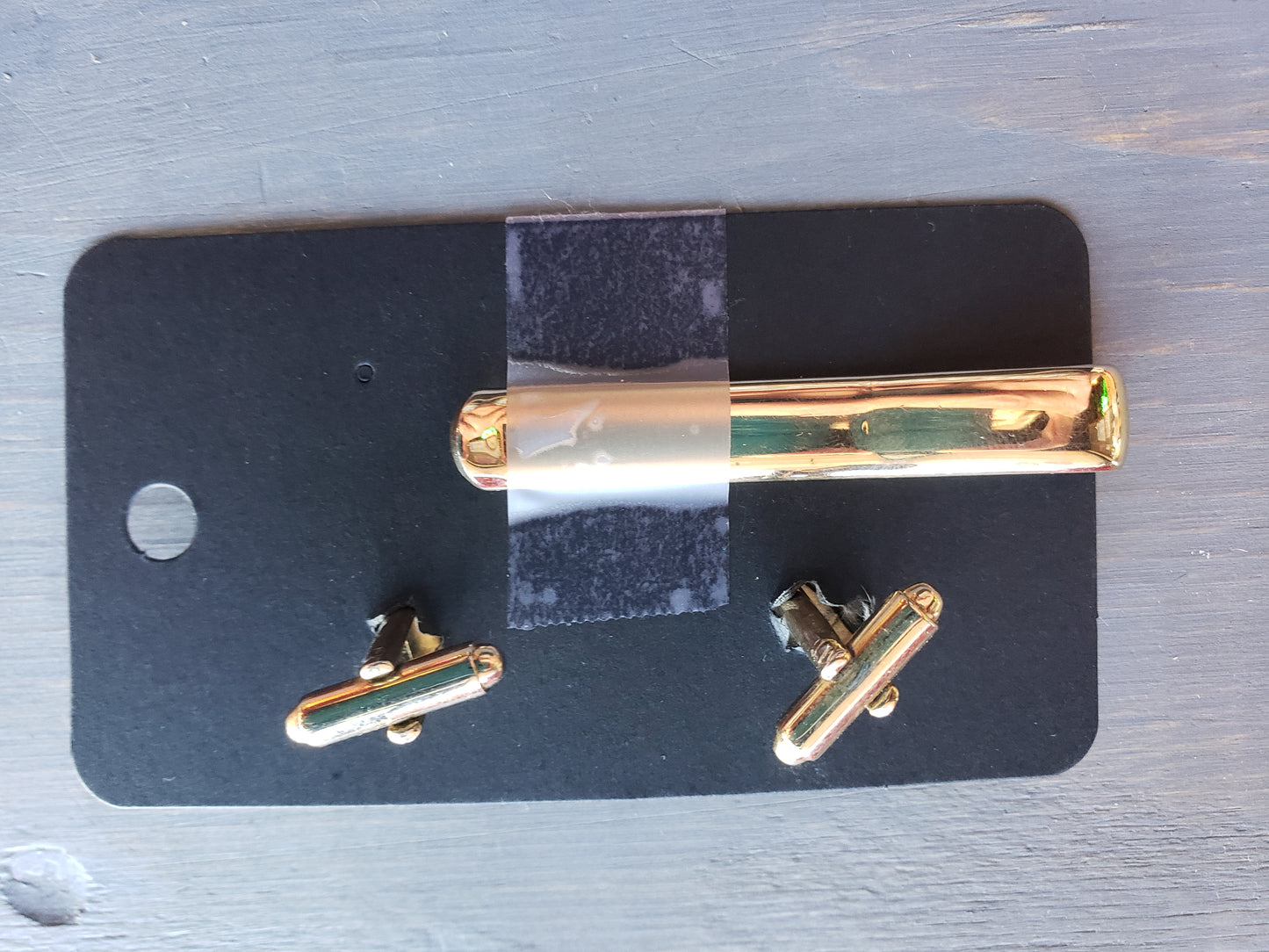 Golden tie bar and cufflink set