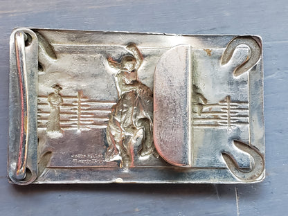 Vintage bucking horse and horse shoes belt buckle