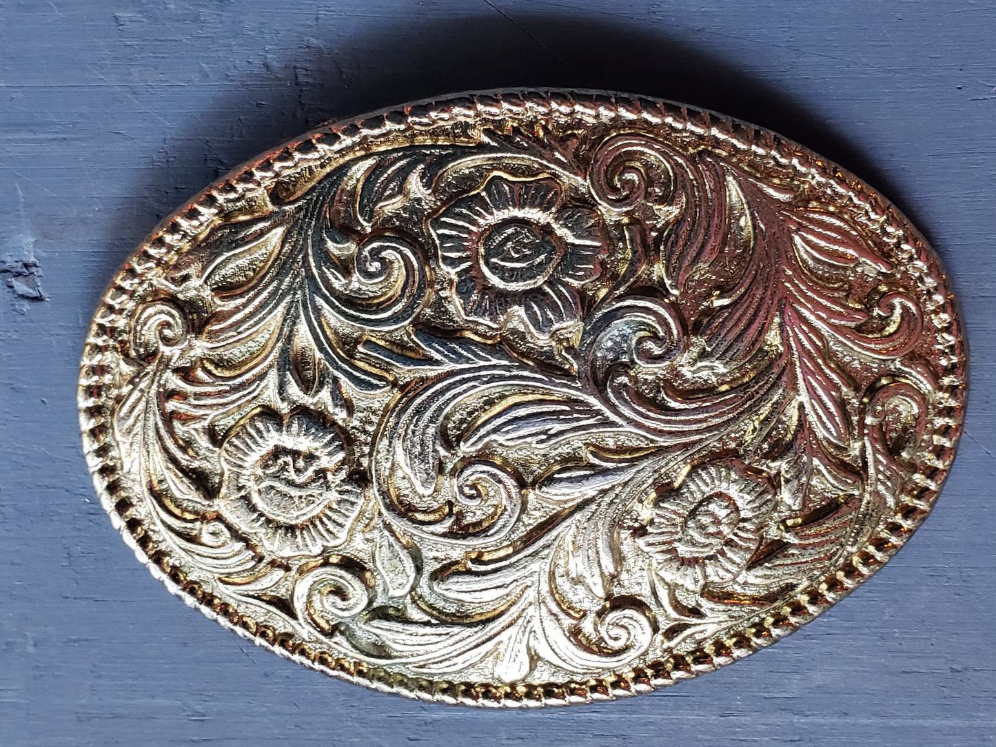Oval gold tone floral scroll belt buckle