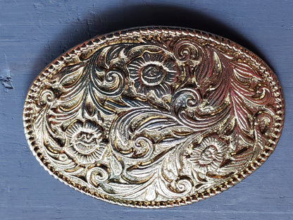 Oval gold tone floral scroll belt buckle