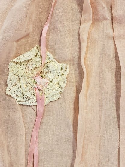 Peach baby dress with lace rosettes