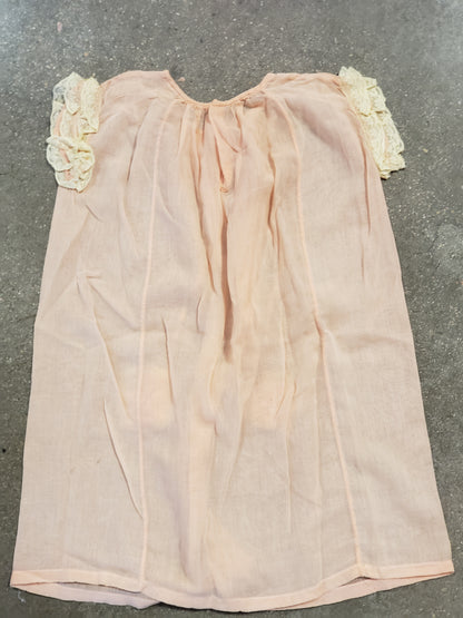 Peach baby dress with lace rosettes