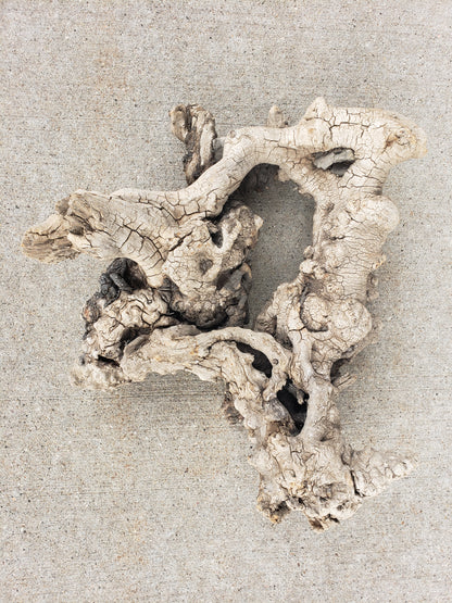 Driftwood sculpture with imbedded rocks