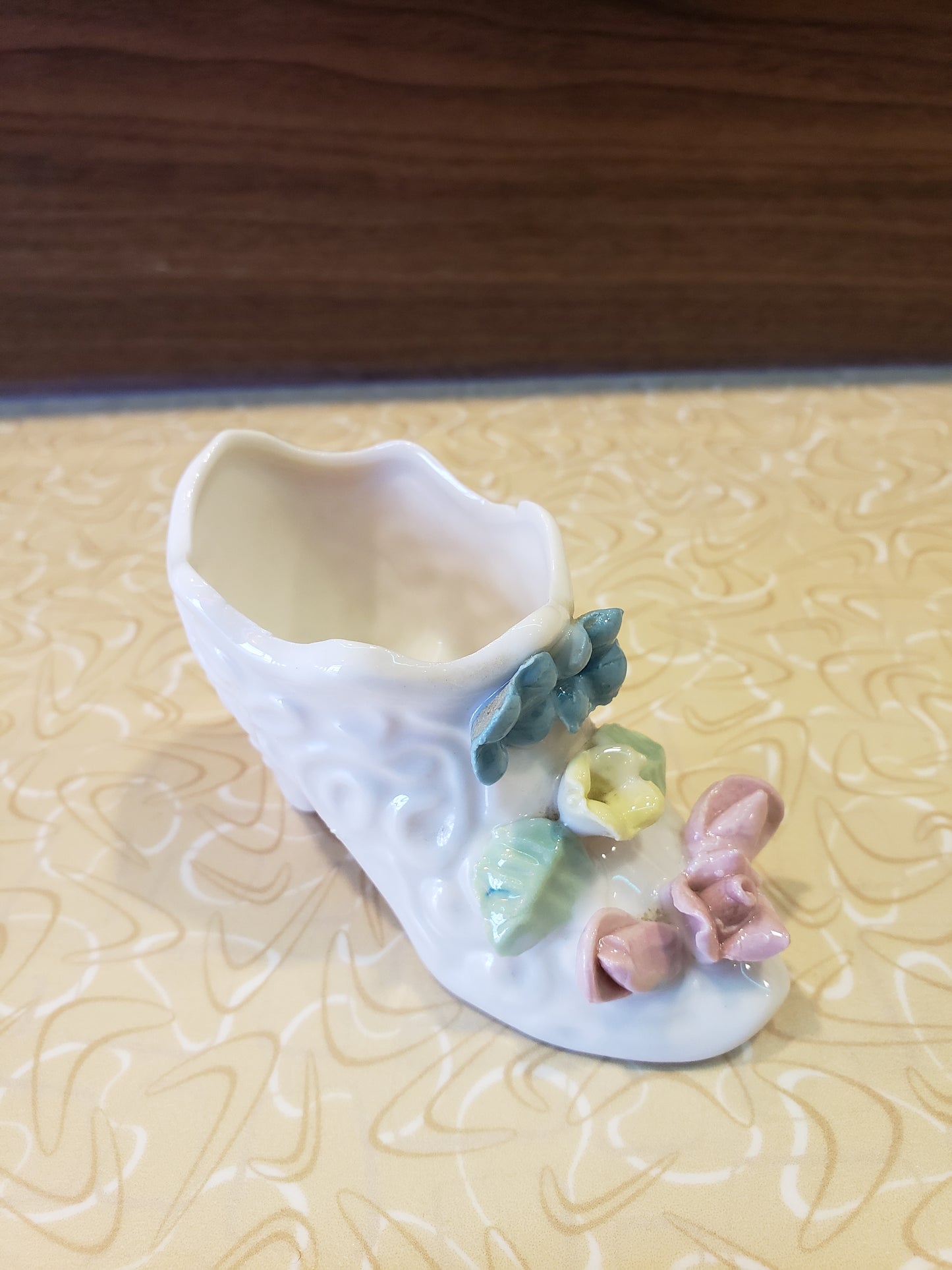 Delicate white porcelain shoe with flowers