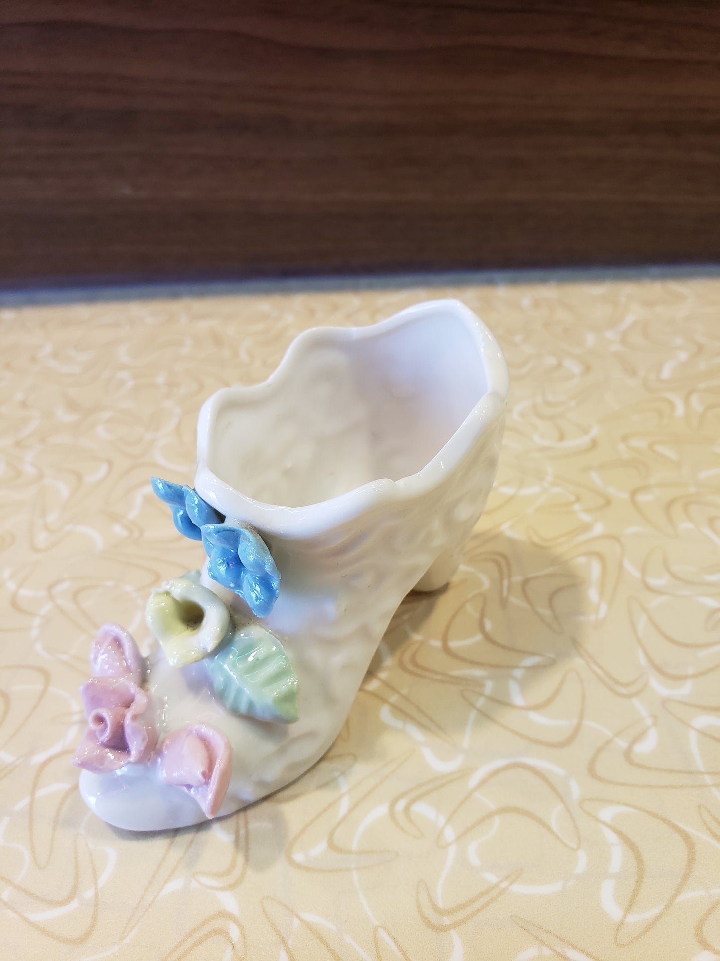 Delicate white porcelain shoe with flowers