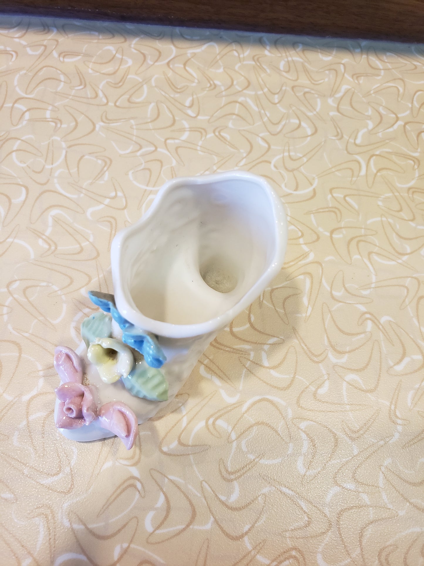 Delicate white porcelain shoe with flowers